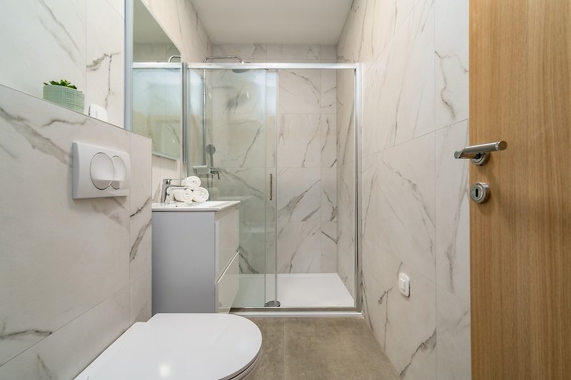 A separate family bathroom with a shower.