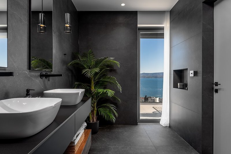 En-suite bathroom with a shower and sea views.