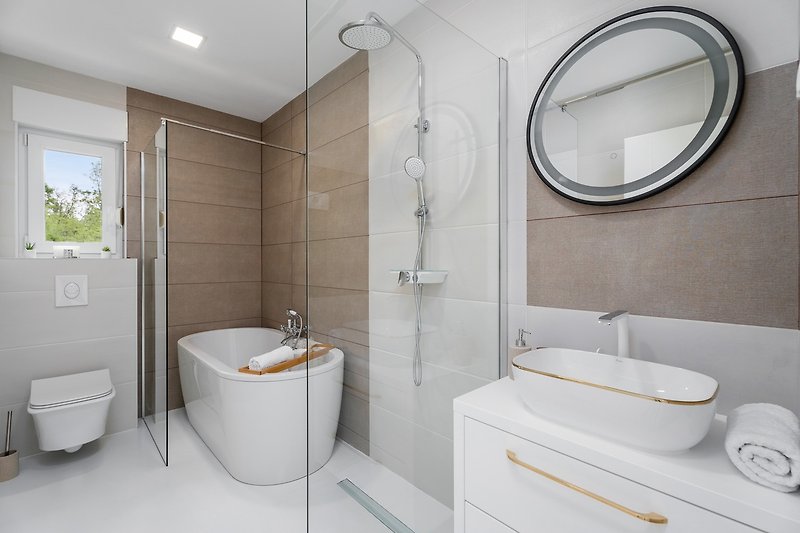 A Family bathroom with a bathtub and a shower is used by Bedroom NO2 and Bedroom NO3.