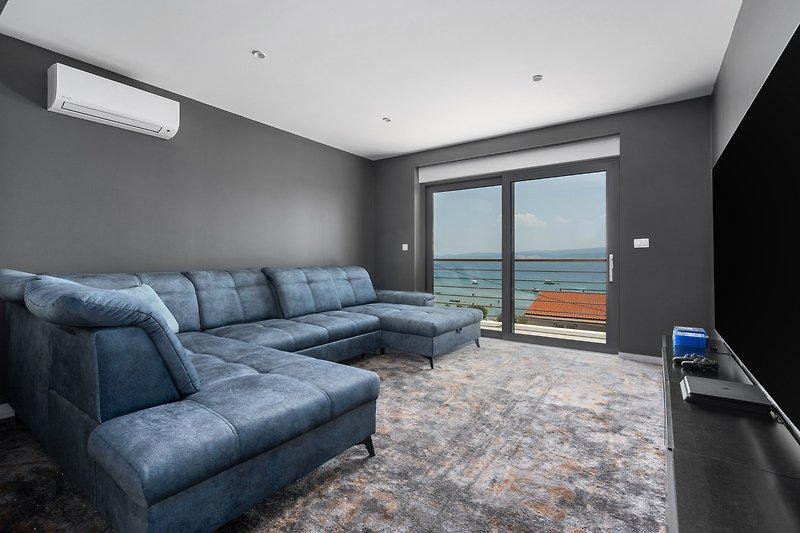 Media room with an TV, PS4, air conditioning, and a balcony with sea views
