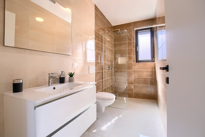 A modern bathroom with sleek fixtures and a stylish sink.