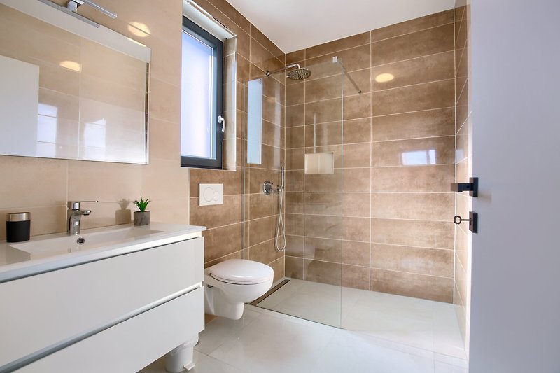 A modern bathroom with sleek fixtures and a stylish mirror.