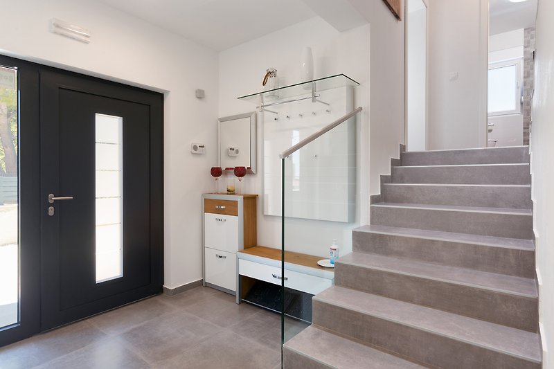 Stylish interior design with hardwood flooring and glass door.