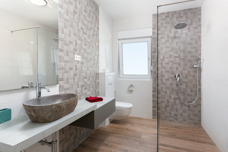 Stylish bathroom with modern fixtures and elegant lighting.