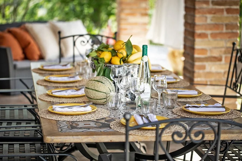 Villa Amata - Veranda mit Tisch, Stühlen und Sitzecke