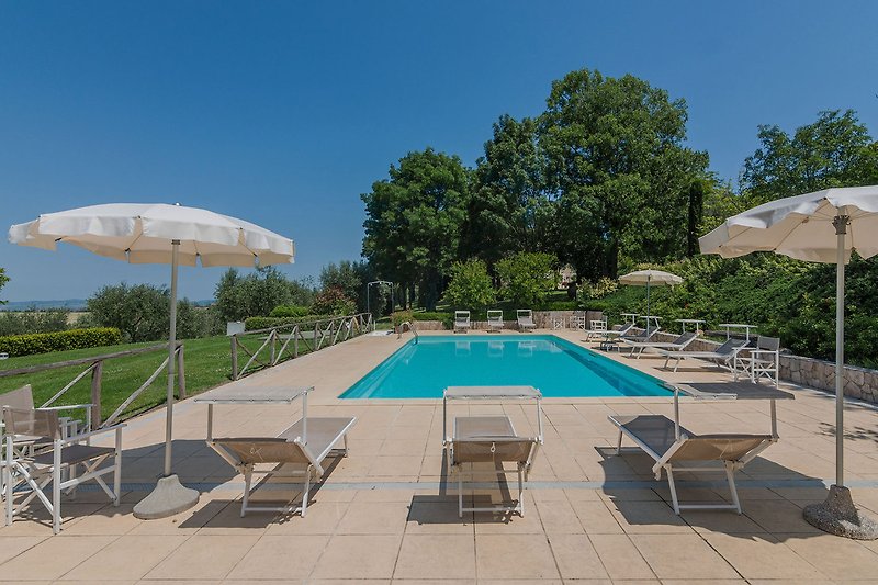 Villa Il Fiore e la Farfalla – Pool mit Sonnenliegen und Sonnenschirmen