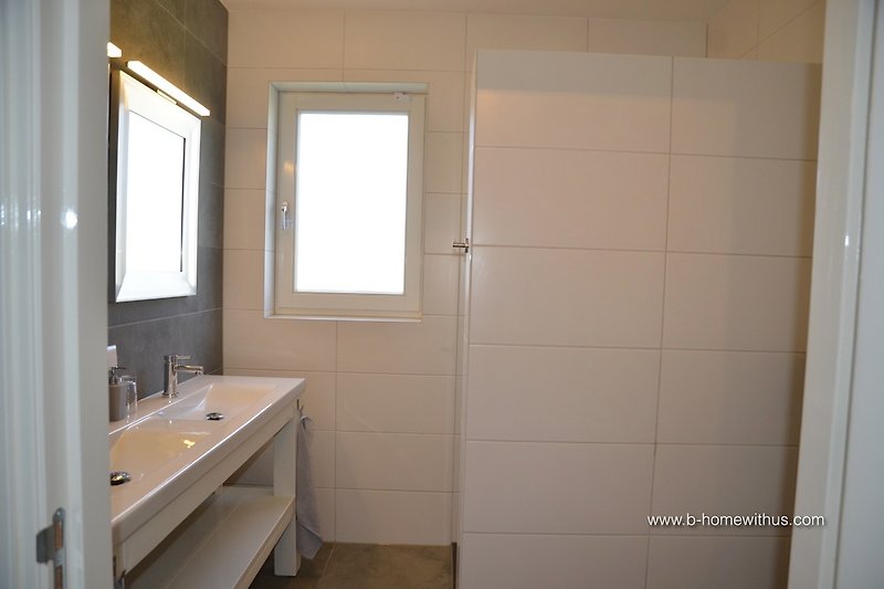 Bathroom with shower, sink and toilet.