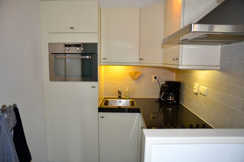 Kitchen with dishwasher and combi oven.
