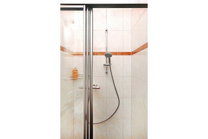 Ein modernes Badezimmer mit Dusche und eleganten Armaturen.