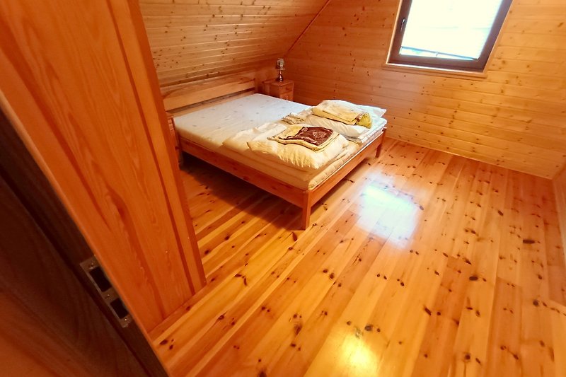 Holz, Fenster, gemütliches Schlafzimmer mit Bett und Bettwäsche.