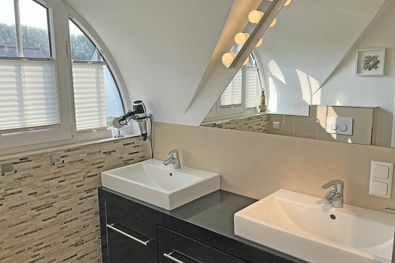 Schönes Badezimmer mit stilvollem Waschbecken und modernem Schrank.