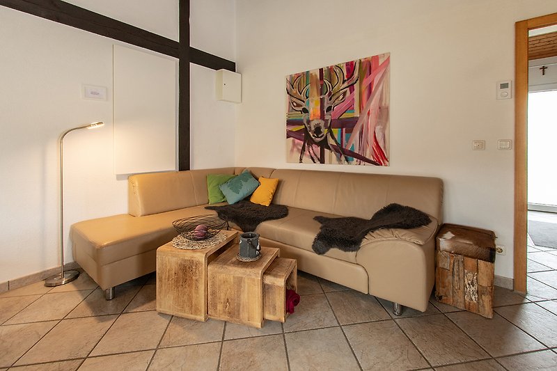 Wohnzimmer mit gemütlicher Couch und Kunst.