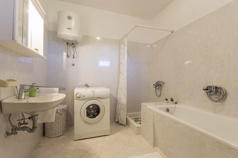 A modern bathroom with a sleek bathtub, elegant sink, and stylish fixtures.