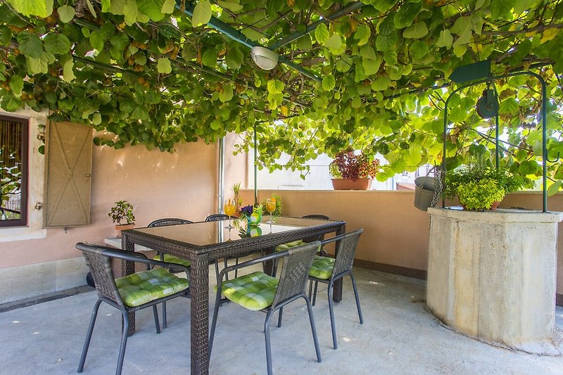 Rent this charming property with a beautiful outdoor table, furniture, and plant.