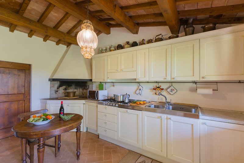 Una cocina moderna con encimeras de madera, armarios elegantes y un fregadero de acero inoxidable.