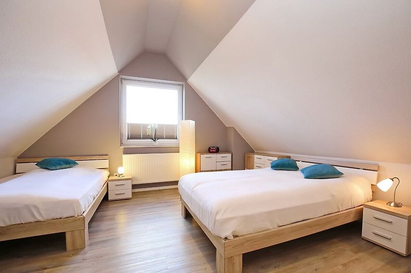 Schlafzimmer im Spitzboden mit Doppelbetten