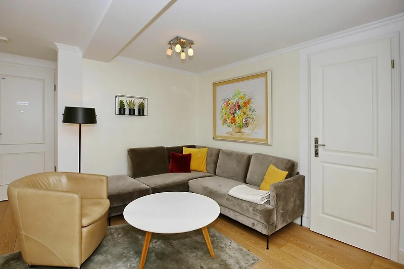 Wohnzimmer mit Ecksofa und Sessel