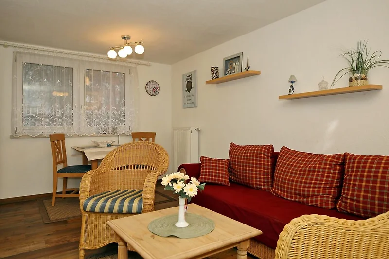 Wohnzimmer mit Sofa und Korbsesseln