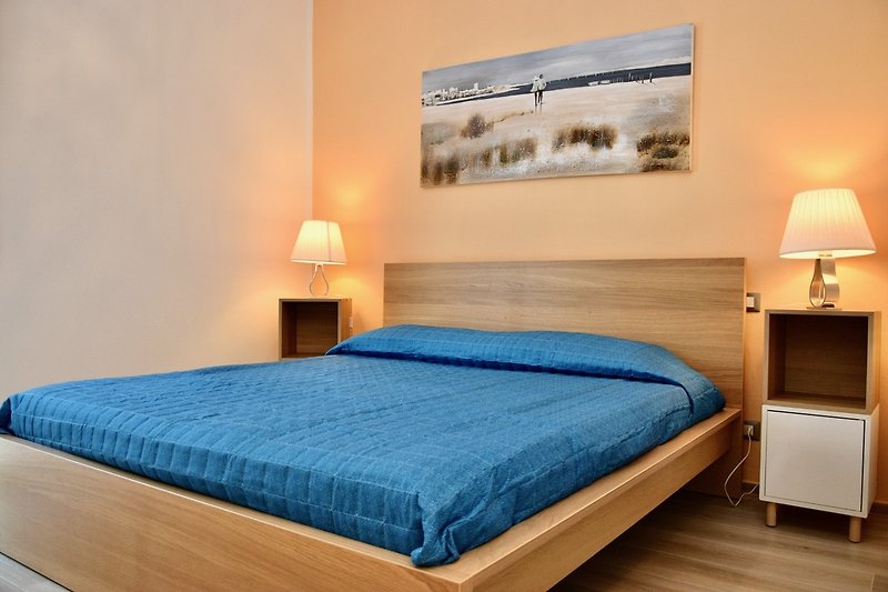 Una camera da letto confortevole con arredamento in legno e luce soffusa.