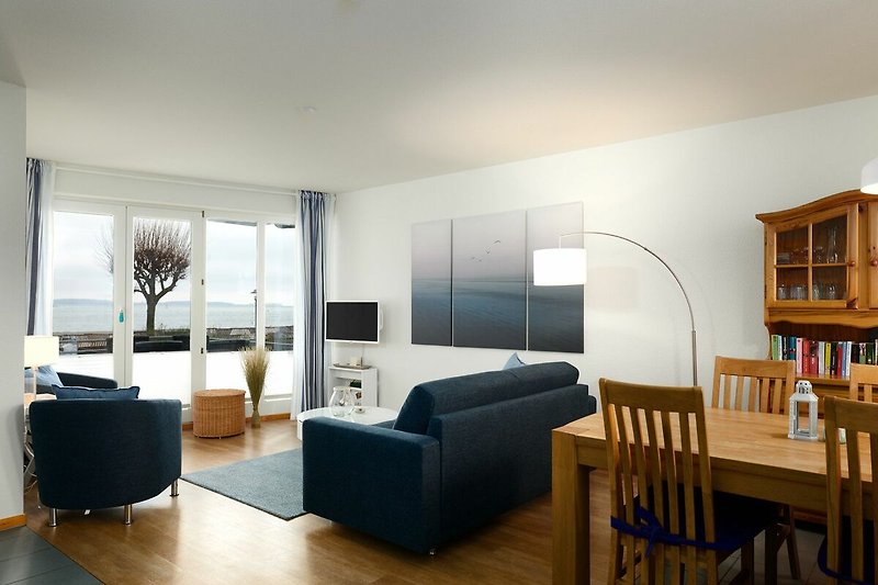 Essbereich und Wohnzimmer mit Balkon und schönem Blick auf die Kieler Förde und den Laboer Kurstrand