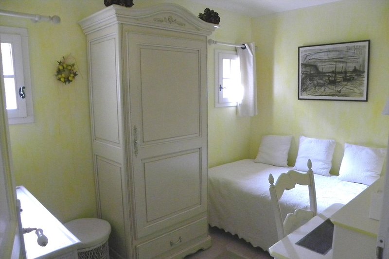The small room with a single bed.