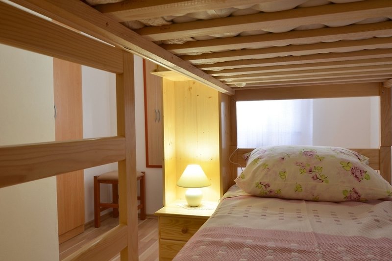 A cozy bedroom with comfortable bedding and warm wood accents.