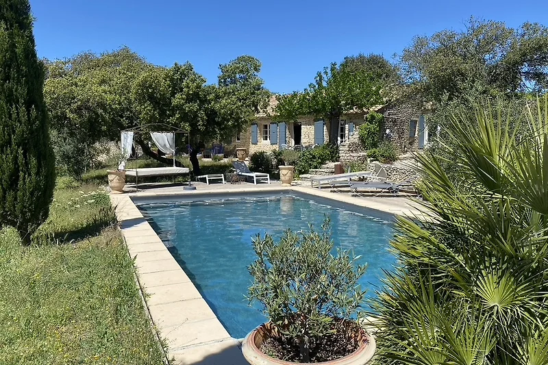 Luxuriöser Pool mit Garten und Blick auf Wasser.