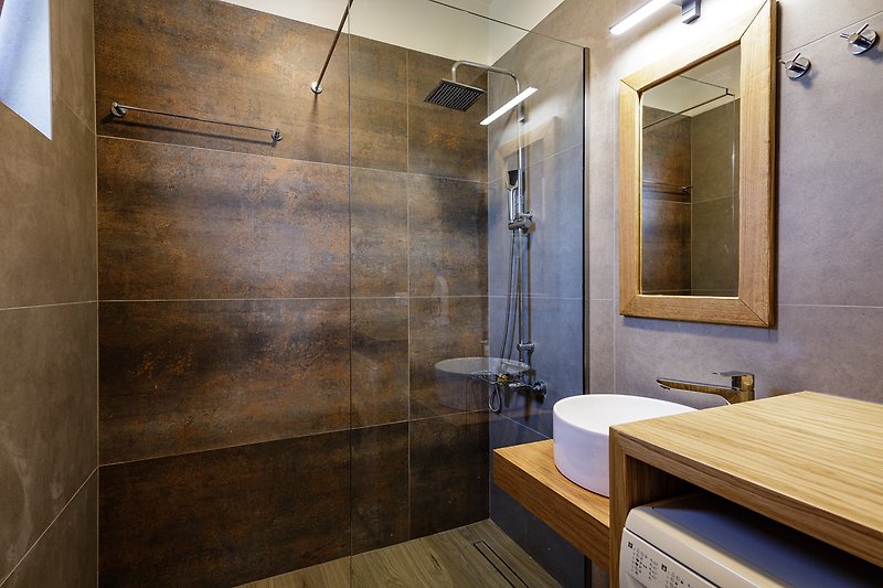 Stylish bathroom with modern fixtures and a sleek shower panel.