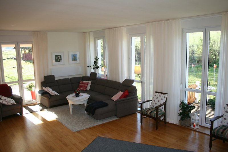 Large living area with a view of the greenery.