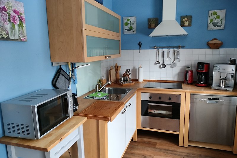 Gemütliche Küche mit modernen Geräten und Holzmöbeln.