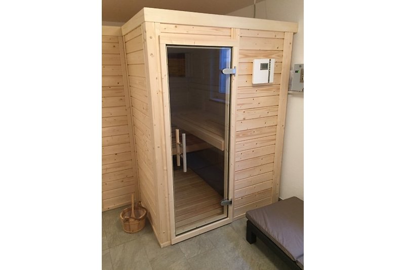 Sauna with two loungers and an additional bench.