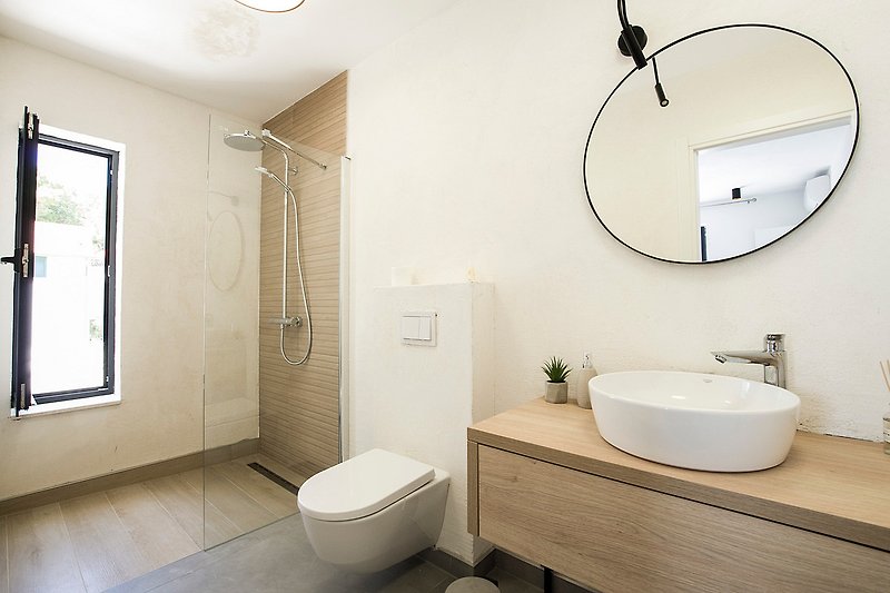 Modern bathroom with purple accents, sleek fixtures, and elegant design.
