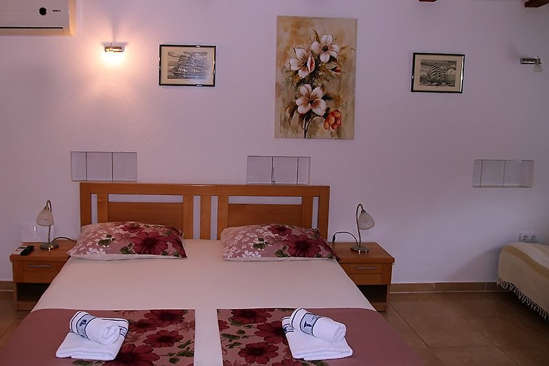 Bedroom with double bed and satellite TV