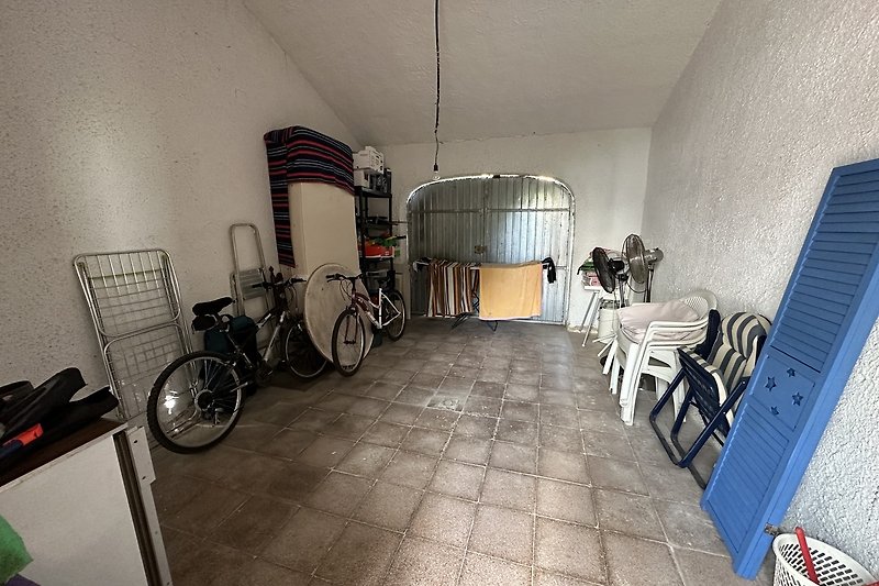 Garage with spare fans, beach stuff, washing machine, bicycles