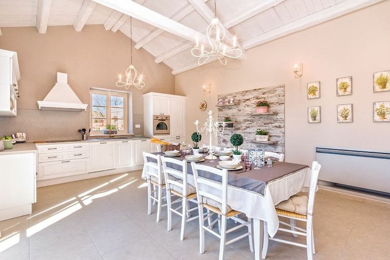 Rent this charming kitchen with stylish furniture, wooden flooring, and beautiful tableware.