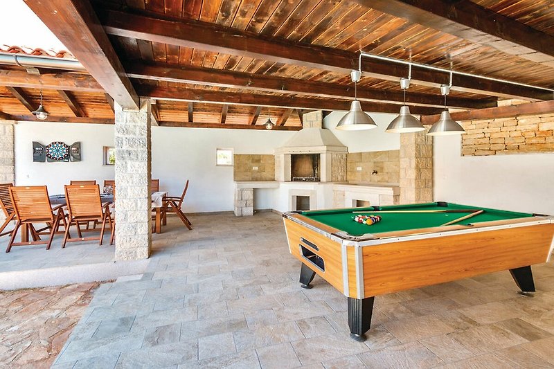 Rent this stylish billiard room with a pool table, comfortable furniture, and elegant interior design.