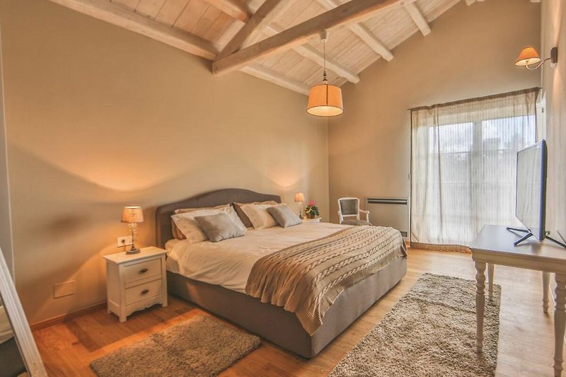 Rent this cozy bedroom with comfortable furniture, warm lighting, and a stylish bed frame.