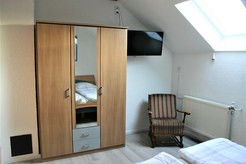 Holzmöbel und moderne Einrichtung in einem komfortablen Schlafzimmer.
