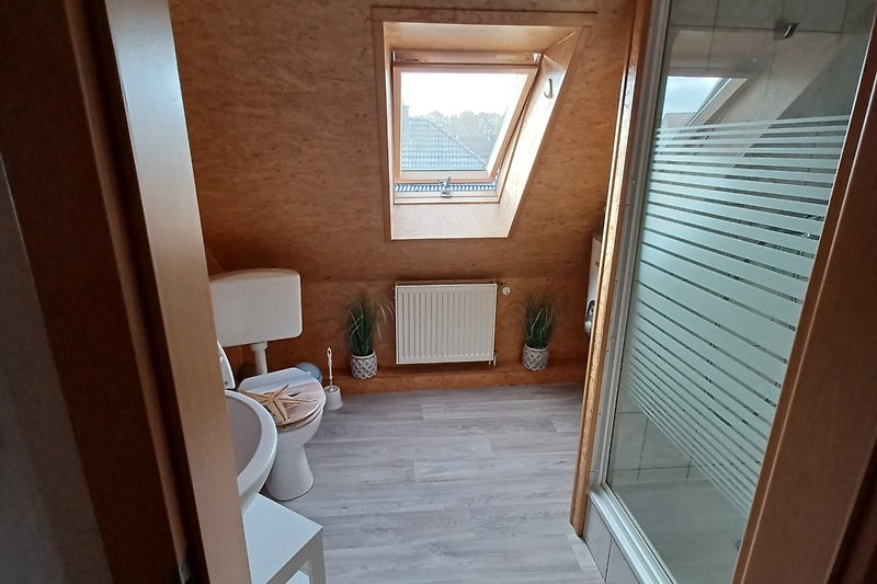 Haus mit Holzboden, Fenstern und modernem Badezimmer.