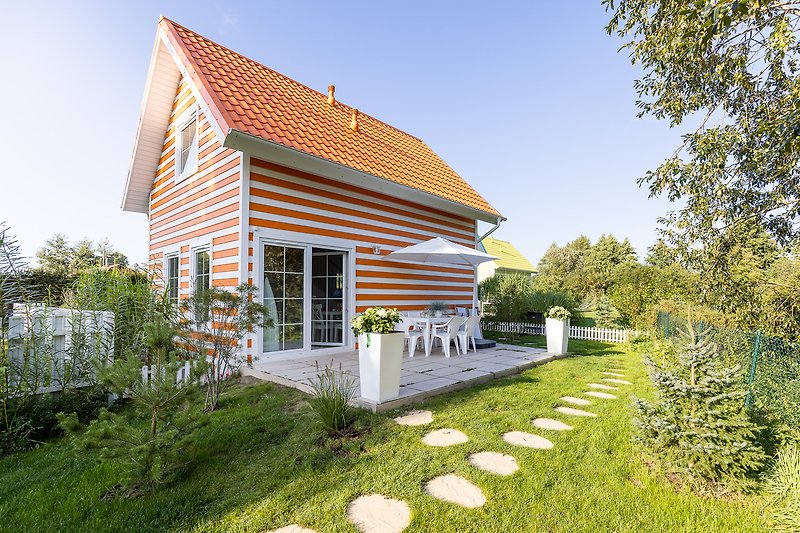 Piękny dom na wsi z dużym ogrodem i zadbanym trawnikiem.