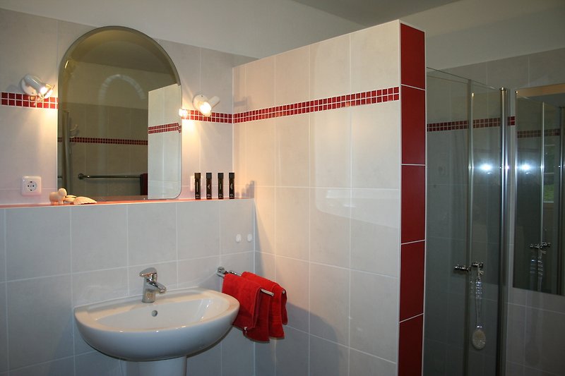 The bathroom with a modern floor-level shower.