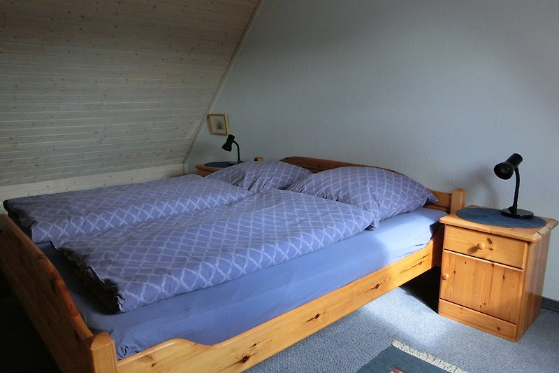 Schlafzimmer mit Doppelbett im Dachgeschoss.