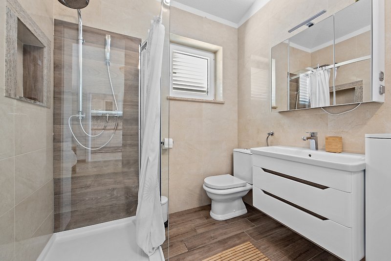 Elegant bathroom with modern fixtures and stylish shower panel.