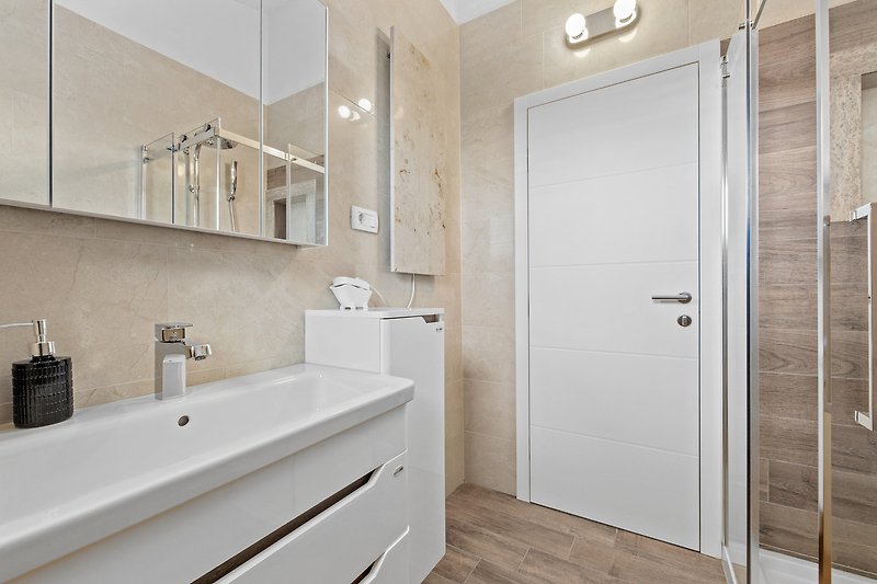 Elegant bathroom with modern fixtures and stylish lighting.