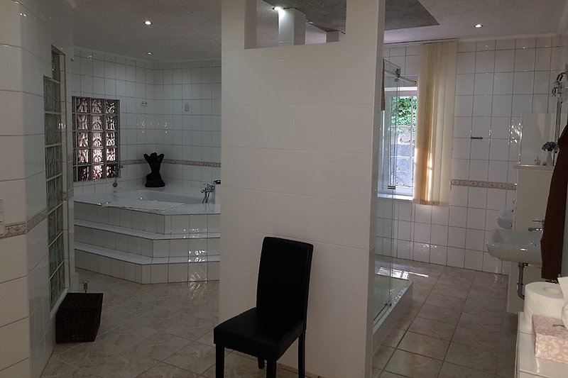 Large bathroom with shower and tub.