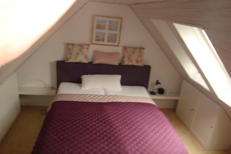Attic bedroom with a view of the dike.