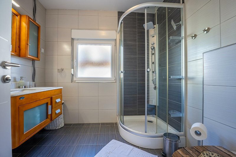 Schönes Badezimmer mit stilvollem Interieur und moderner Ausstattung. Perfekt für einen erholsamen Urlaub.