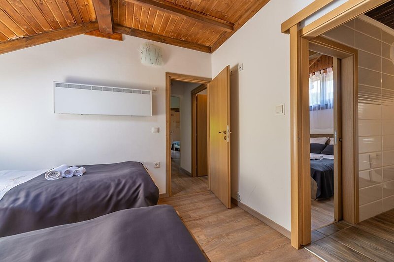 Gemütliches Schlafzimmer mit bequemem Bett und stilvollem Holzboden. Perfekt zum Entspannen und Träumen.