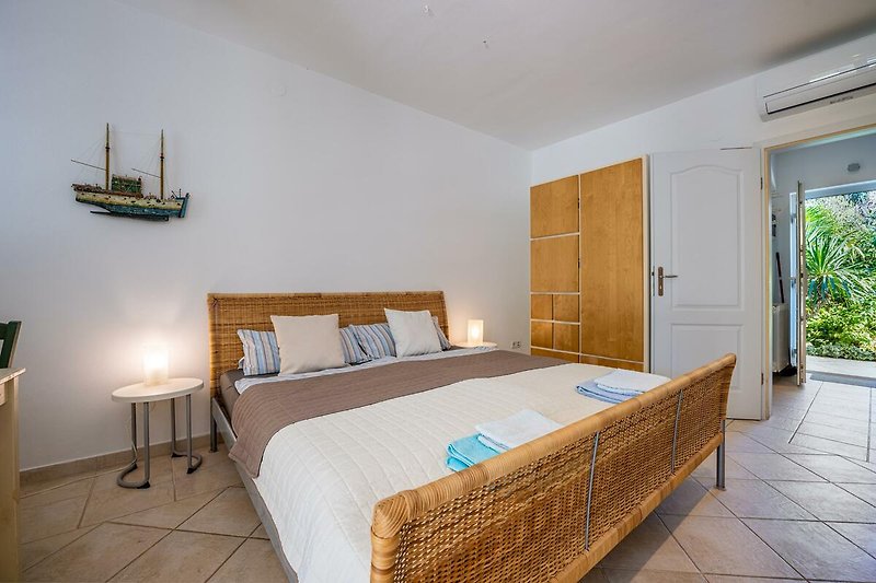 Komfortables Schlafzimmer mit stilvollem Holzmobiliar und gemütlichem Bett.