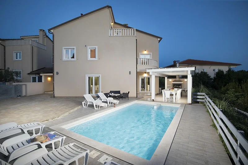 Villa mit Pool, Balkon und stilvollen Outdoor-Möbeln im Resort.